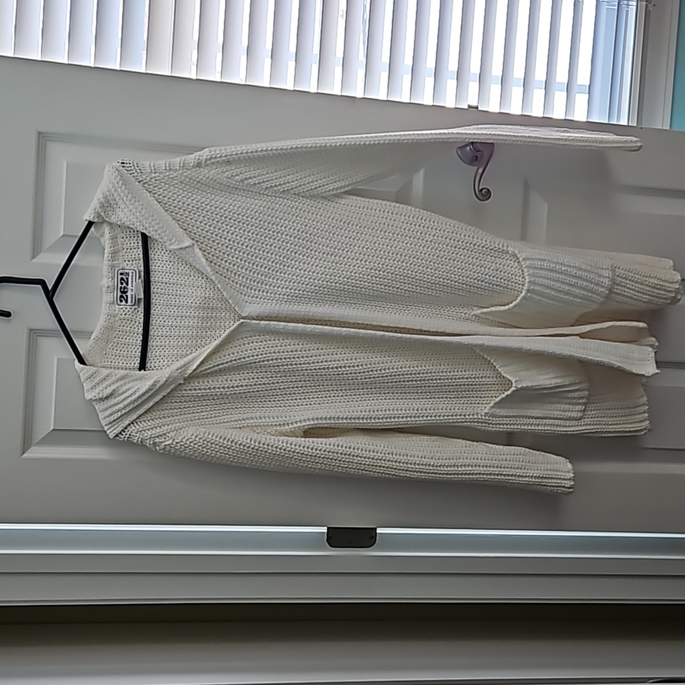 White, 100% cotton knit sweater. Size medium 2 pockets, 1 eye hook closure.